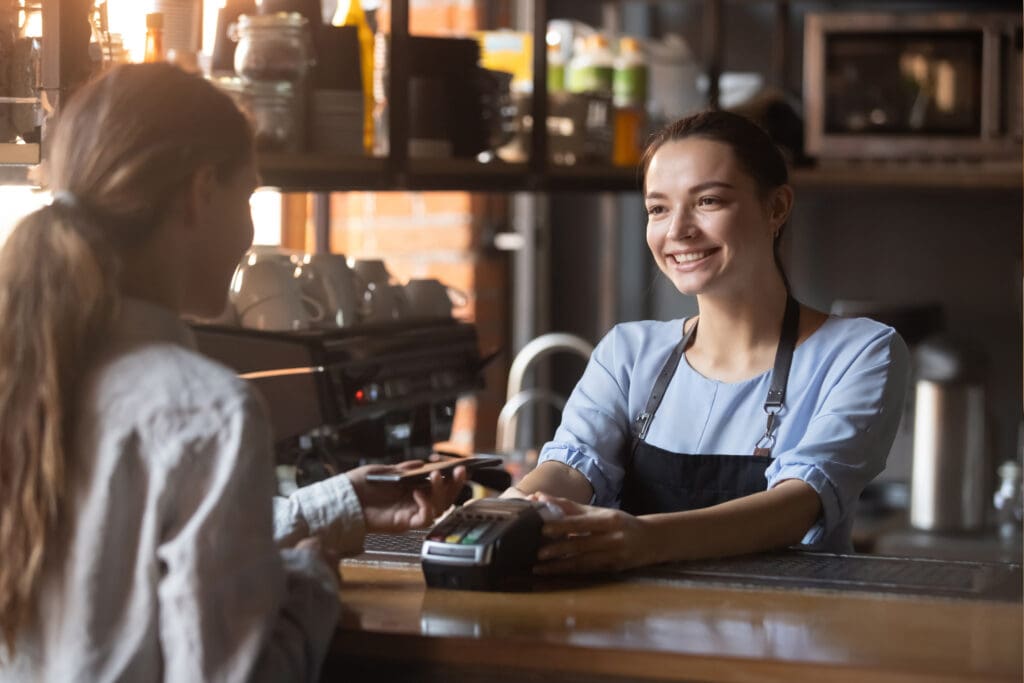 Customer,Making,Wireless,Or,Contactless,Payment,Using,Credit,Card.,Smiling